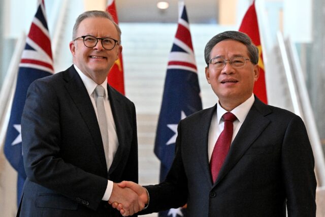 Prime Minister Anthony Albanese (L) shakes hands with Premier Li Qiang, the highest-rankin