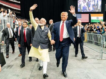 President Donald J. Trump holds hands with Prime Minister Narendra Modi of India as they t