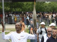 Snoop Dogg Carries the Olympic Torch Before Opening Ceremony in Paris