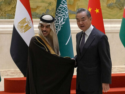 Chinese Foreign Minister Wang Yi, right, shakes hands with Saudi Arabia's Foreign Minister