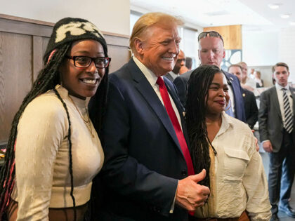 Republican presidential candidate former President Donald Trump, center, takes a photo wit