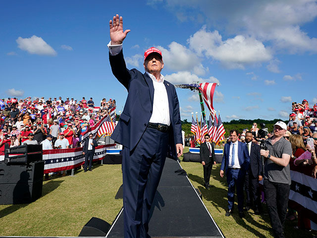 Republican presidential candidate former President Donald Trump waves at a campaign rally