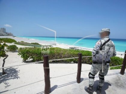 A Mexican soldier stands guard on a beach ahead of Hurricane Beryl's expected arrival, in