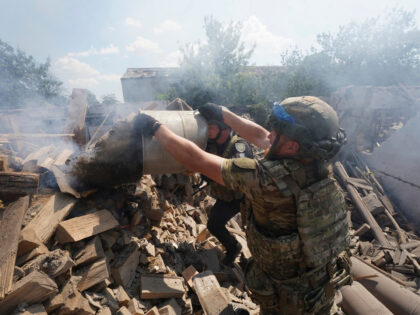 Police officers extinguish a fire after Russian airstrike on residential neighbourhood of