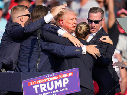 Republican presidential candidate former President Donald Trump is helped off the stage at