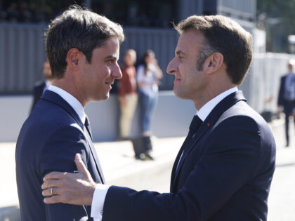 French President Emmanuel Macron, right, is greeted by French Prime Minister Gabriel Attal