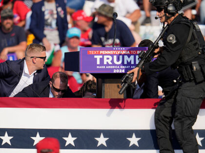 Republican presidential candidate former President Donald Trump is surrounded by U.S. Secr