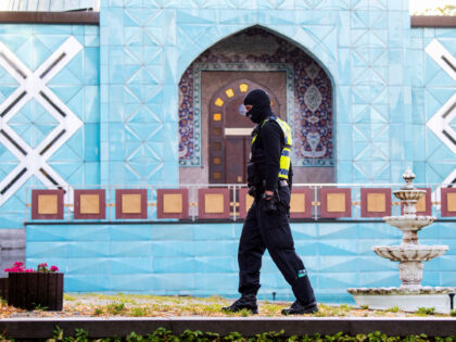 A police officer stands outside the Islamic Center Hamburg with the Imam Ali Mosque during