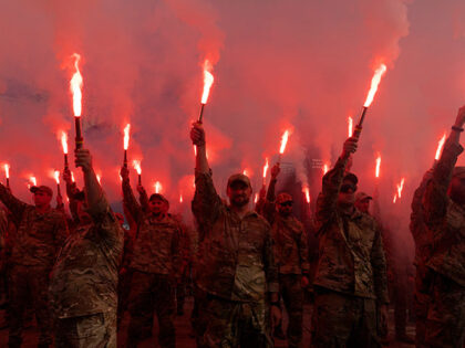 Soldiers of Ukraine's Azov battalion light flares at a rally demanding the release of Ukra