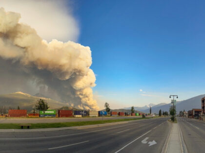 In this photo released by the Jasper National Park, smoke rises from a wildfire burning ne