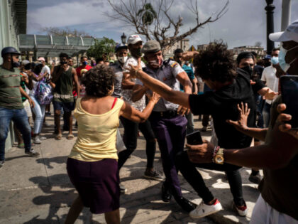 Police scuffle and detain an anti-government demonstrator during a protest in Havana, Cuba