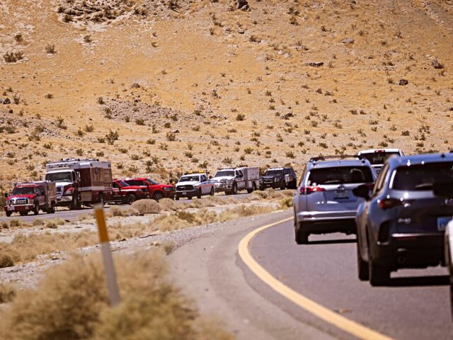 Law enforcement agencies vehicles are seen gathered by the scene of an overturned truck fi