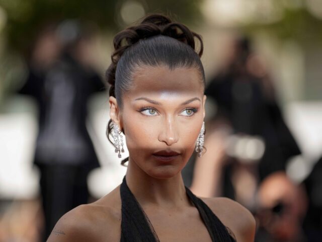 Bella Hadid poses for photographers upon arrival at the premiere of the film 'Beating