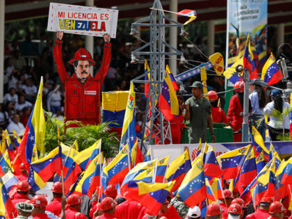 Supporters carry an image depicting President Nicolas Maduro during the Independence Day m