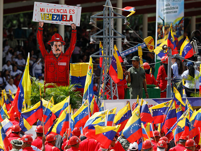Supporters carry an image depicting President Nicolas Maduro during the Independence Day m