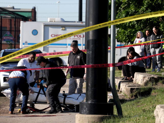 People watch the scene where two people were fatally shot at La Villita Park in the Little