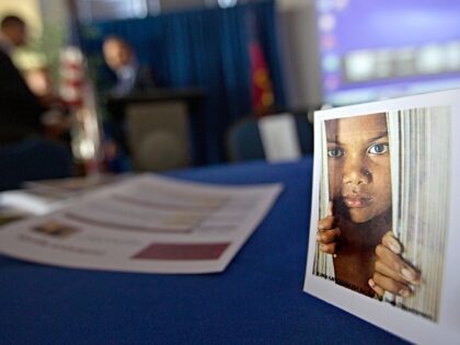 A placard of a child sits on a table during a conference on human sex trafficking Monday,