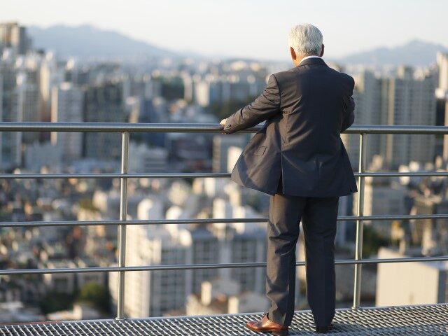 Elderly man on balcony