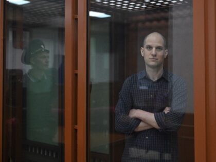 US journalist Evan Gershkovich, accused of espionage, looks out from inside a glass defend