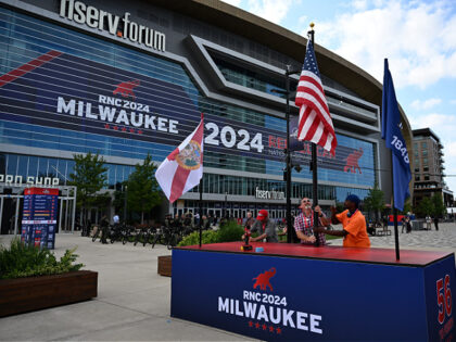 Flags are raised outside the Fiserv Forum ahead of the Republican National Convention (RNC