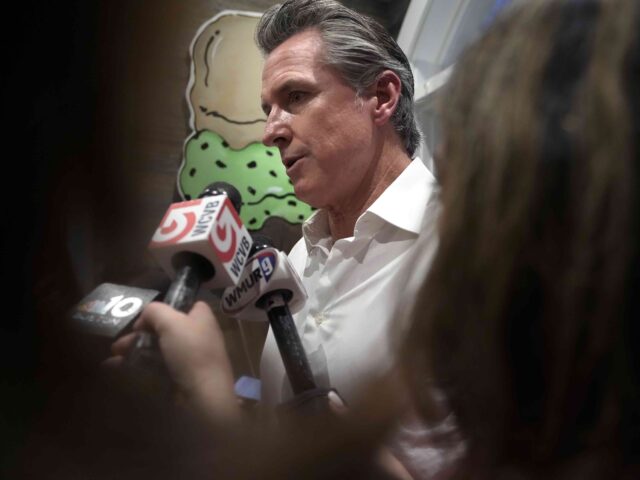 California Gov. Gavin Newsom speaks to reporters Monday, July 8, 2024, in a donut shop, in