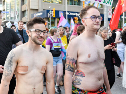 A naked protester smiles during the Trans march. Spectators displayed their support toward