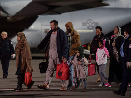 Afghan refugees, fleeing the Afghan capital Kabul, exit an US air force plane upon their a