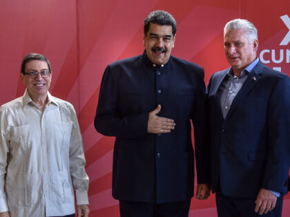 Cuban President Miguel Diaz-Canel (R) and Foreign Minister Bruno Rodriguez (L) pose for a