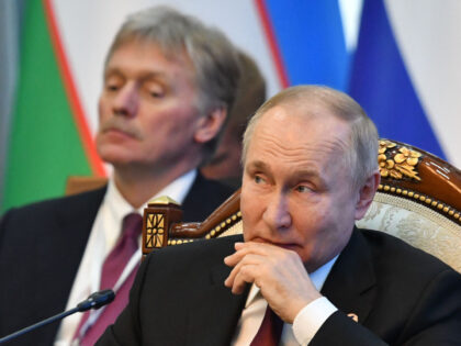 Russia's president Vladimir Putin (R) and his spokesman Dmitry Peskov (L) attend the Supre