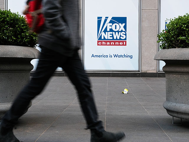 People walk by the News Corporation headquarters, home to Fox News, on April 18, 2023 in N