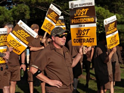 UPS workers and Teamsters members practice picket outside a UPS distribution facility in M