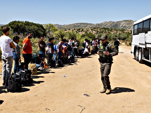 JACUMBA HOT SPRINGS, CA - JUNE 18: Migrants wait to be processed by the U.S. Border Patrol