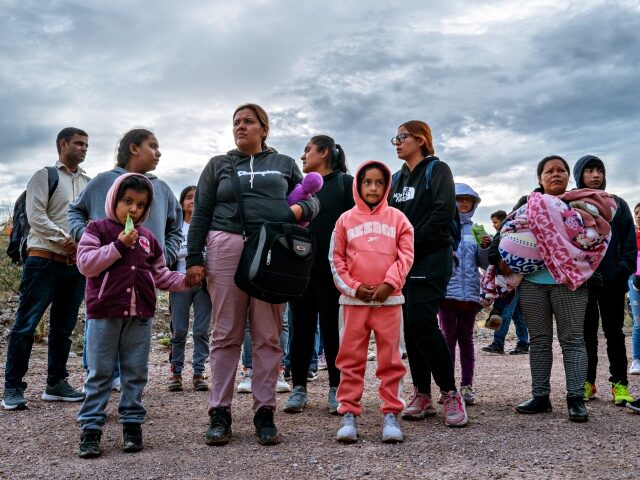 RUBY, ARIZONA - JUNE 25: A group of migrants from South and Central America wait to be app