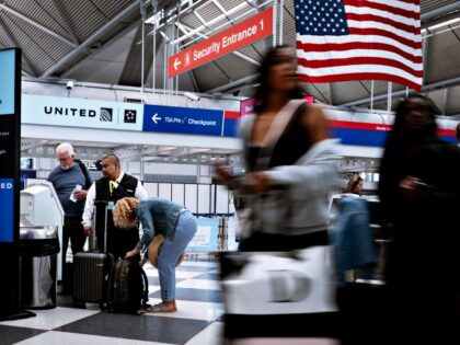 CHICAGO, ILLINOIS - JUNE 28: Passengers pass through O'Hare airport during the start