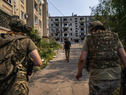 DONETSK OBLAST, UKRAINE - JULY 5: Ukrainian soldiers run for shelter from Russian army att