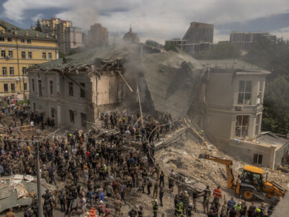 TOPSHOT - Emergency and rescue personnel along with medics and others clear the rubble of