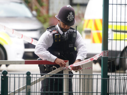 A police officer at an address in Shepherd's Bush, west London, after human remains were f