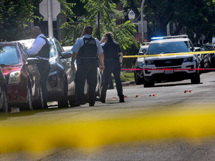 Police investigate the scene of a drive-by shooting on July 06, 2024 in Chicago, Illinois.