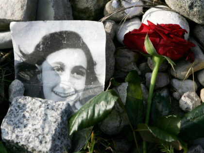 A picture of Anne Frank lies in front of the memorial stone for Jewish girl Anne Frank, au