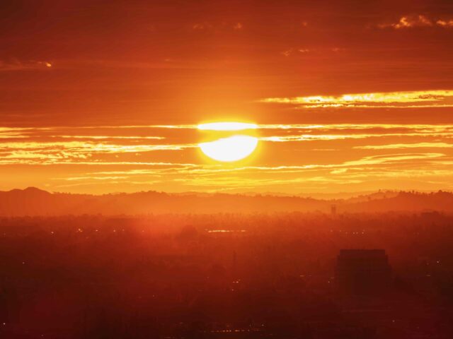 Los Angeles fiery morning sun bursting through clouds and fog above the San Fernando Valle