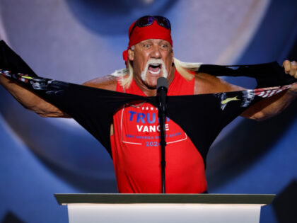 Professional entertainer and wrestler Hulk Hogan rips his shirt as he speaks on stage on t