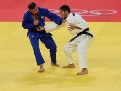 Tajikistan's Nurali Emomali and Israel's Baruch Shmailov (Blue) compete in the j