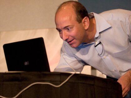 Jeff Bezos looks surprised by laptop