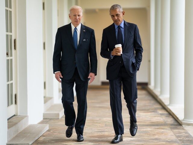 President Joe Biden and former President Barack Obama walk along the West Colonnade of the