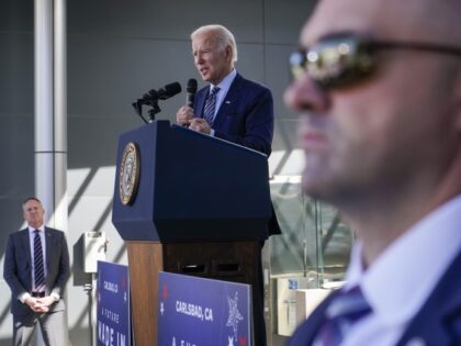 As U.S. Secret Services agents stand at their posts, President Joe Biden speaks about the