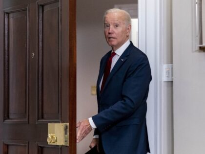 President Joe Biden answers a reporter's question as he leaves after speaking the DIS