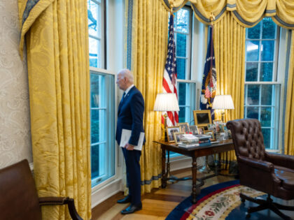 President Joe Biden looks out the window as he reviews remarks he will give on the economy