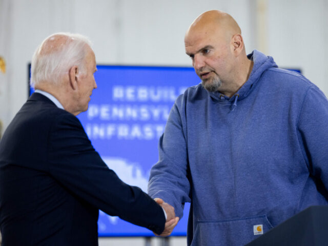 US President Joe Biden shakes hands with US Senator John Fetterman (D-PA) following a brie