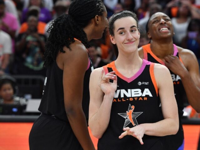 PHOENIX, AZ - JULY 20: Caitlin Clark #22 of Team WNBA smiles after the game against the US