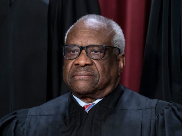 FILE - Associate Justice Clarence Thomas joins other members of the Supreme Court as they